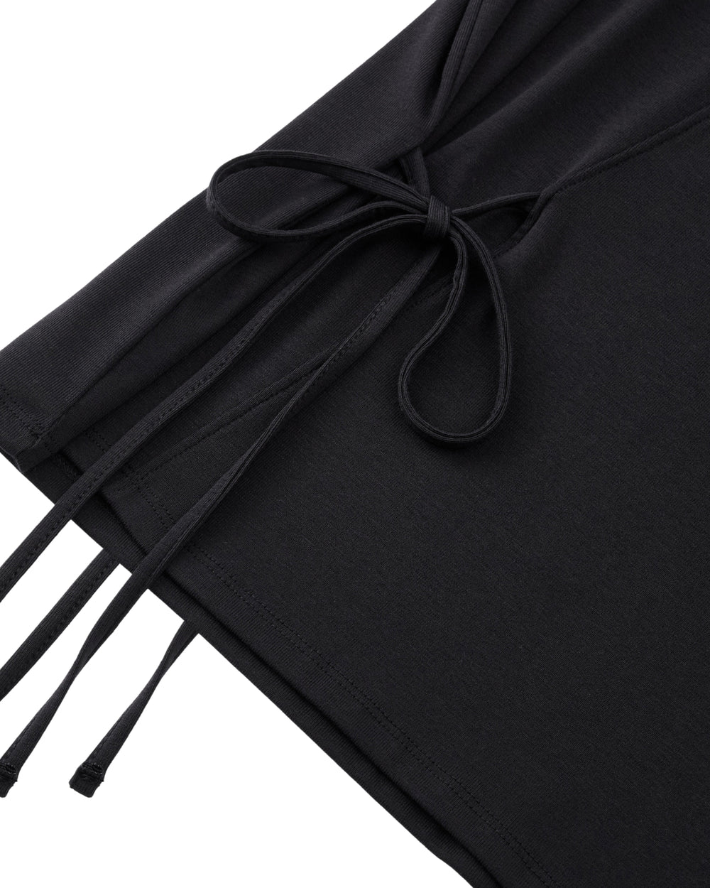 Close-up of the BLACK ORIGAMI GORUM TEE by Sundae School, showcasing a side tie detail with thin, matching black strings, neatly bow-tied, against a white background.