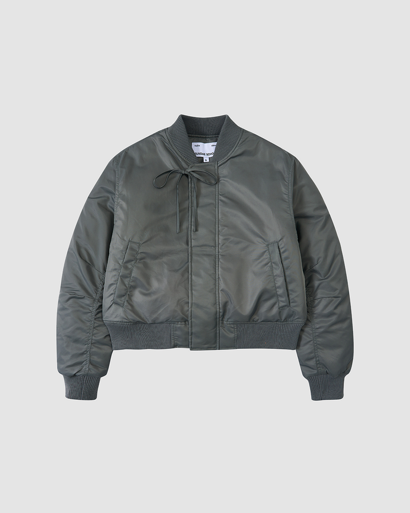 A flatshot of Sundae School Khaki Flower Channeled Bomber against a white background.