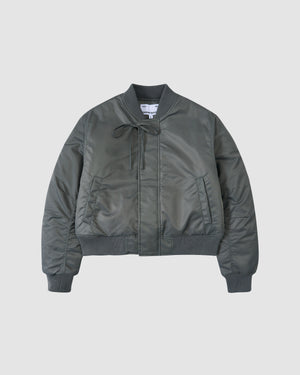 The KHAKI FLOWER CHANNELED BOMBER by Sundae School is a dark green jacket with ribbed cuffs, collar, and hem, front zipper, side pockets, and a drawstring at the collar, shown against a plain light background.