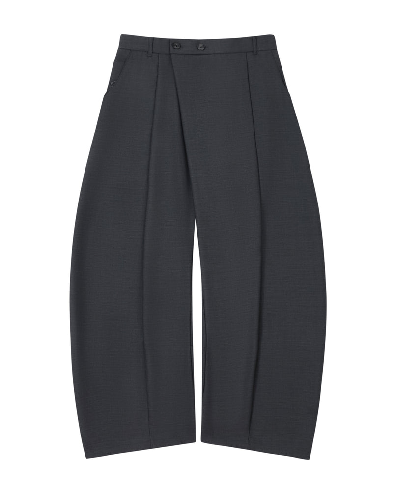 The CHARCOAL PLEATED HANBOK SLACKS by Sundae School are wide-leg, dark gray wool pants featuring deep pleats, a high waist with belt loops and two buttons, and side pockets. Reminiscent of the balloon silhouette found in hanbok pants, they are shown laid flat against a white background.