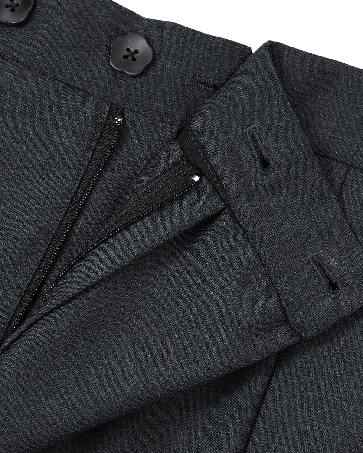 Close-up of the CHARCOAL PLEATED HANBOK SLACKS by Sundae School, showcasing dark gray wool fabric with a partially unzipped fly and two black buttons at the waistband.