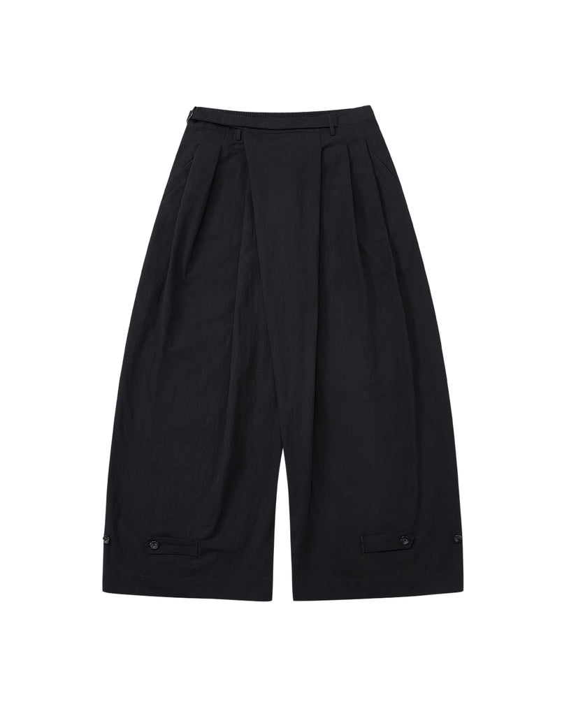 Sundae School’s BLACK PLEATED PALAZZO PANTS feature wide legs, pleats at the waist, a high waistband, mochi button details near the hem, and a mid-calf length. Shown on a light gray background.
