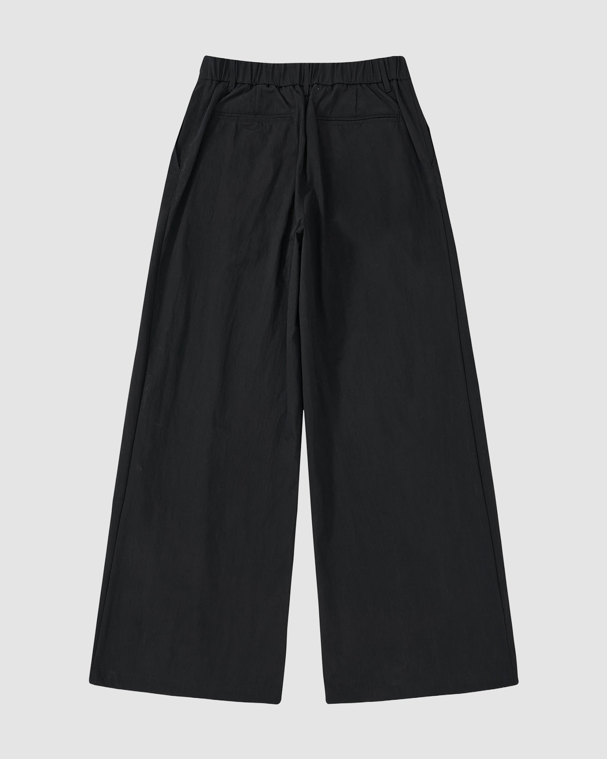 The BLACK PLEATED UNIFORM SLACKS by Sundae School feature a wide-leg, adjustable waist with elastic waistband, two side pockets, and two back welt pockets, shown laid flat on a light gray background.