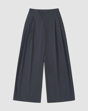 Sundae School CHARCOAL PLEATED UNIFORM SLACKS: wide-leg, high-waisted charcoal trousers with pleats and button closure, displayed flat on a light gray background.