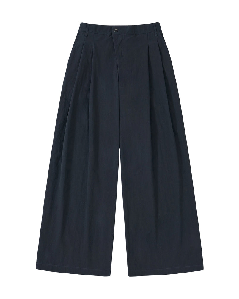 The Sundae School NAVY PLEATED UNIFORM SLACKS feature a high-waisted, wide-leg design with front pleats and side pockets, inspired by modern Korean gyobok and photographed laid flat on a plain light background.