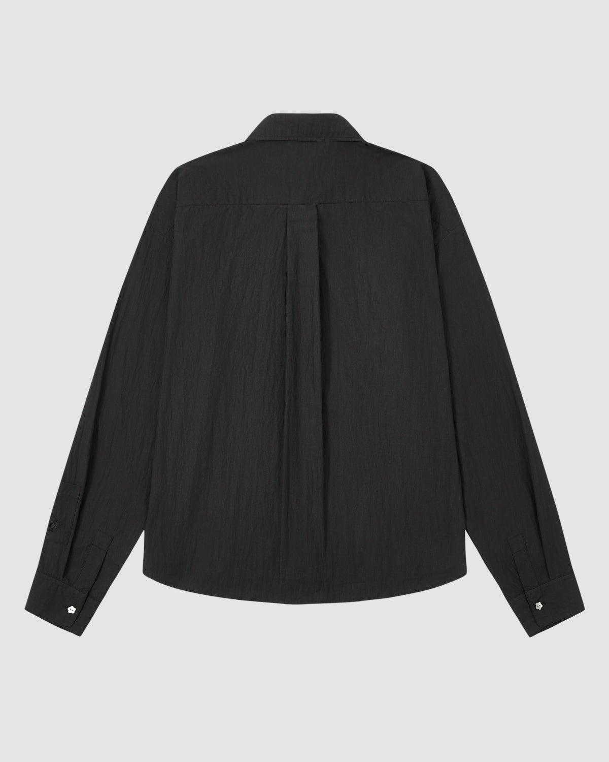 The BLACK POPLIN TIE GORUM SHIRT by Sundae School is displayed from the back, showcasing a central pleat and buttoned cuffs against a plain white background.
