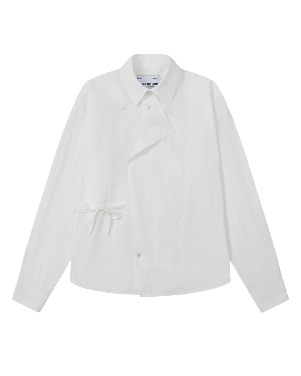A front flat-lay view of an off-white long-sleeve button-up shirt crafted from textured crinkle fabric. It features an asymmetrical wrap-front construction with a side waist tie, a pointed collar, and flower-shaped button details.