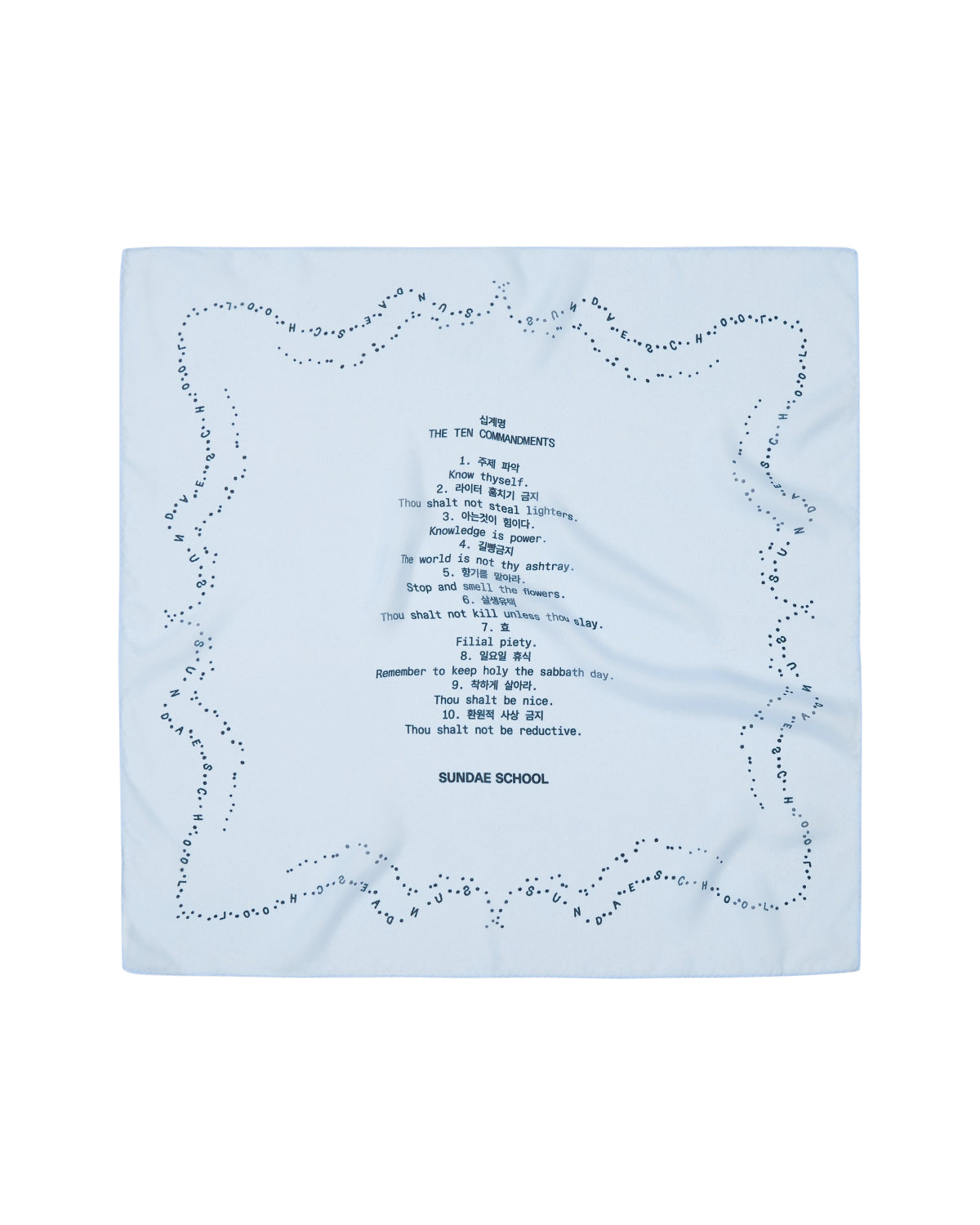 A sheer sky blue organza bandana from Sundae School features decorative dots along the edge and showcases printed text in a sundae-shaped arrangement at the center, including “THE TEN COMMANDMENTS” and “SUNDAE SCHOOL TEN COMMANDMENTS,” among other phrases.