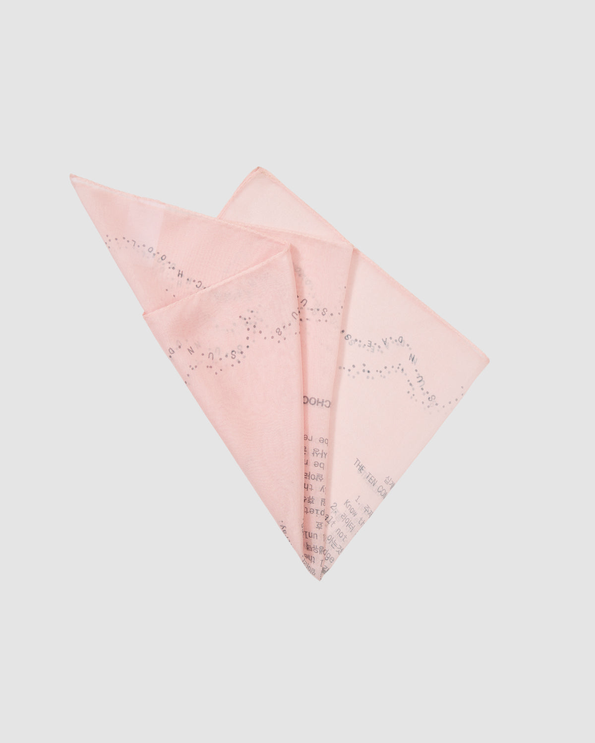 The BABY PINK 10 COMMANDMENTS ORGANZA BANDANA by Sundae School features subtle prints and small text inspired by their Ten Commandments print, shown neatly folded against a plain white background.