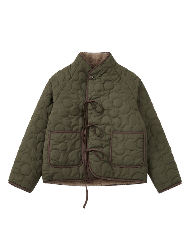 Discover the Sundae School KHAKI REVERSIBLE FLOWER QUILTED JEOGORI FLEECE—a hanbok-inspired jacket featuring flower-pattern quilting, two spacious front pockets, brown trim accents, and tie closures. The unique silhouette is highlighted by its high collar and long sleeves. Inside, a plush beige fleece lining delivers the cozy comfort of a faux-sherpa puffer, blending style and warmth for cooler weather.