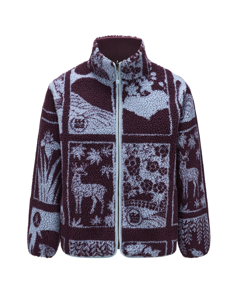 Introducing the PLUM REVERSIBLE GOSTOP FLEECE by Sundae School—a cozy reversible sherpa fleece zip-up jacket with a stand collar. This design showcases a purple and light blue nature-themed patchwork pattern featuring deer and trees, capturing outdoor inspiration in true hwatu style.