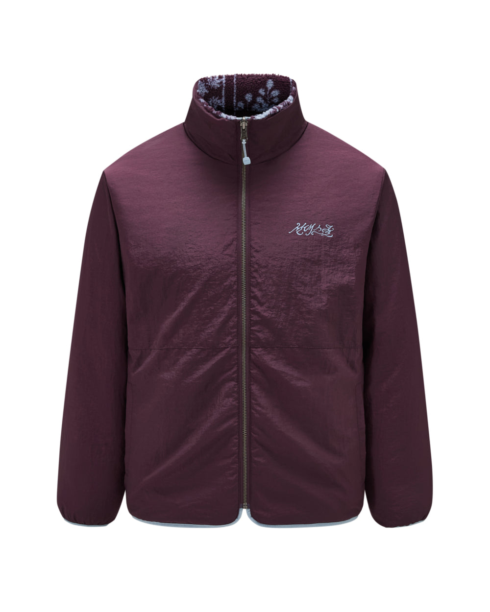 Here’s a rewritten sentence based on your product data: The PLUM REVERSIBLE GOSTOP FLEECE by Sundae School is a maroon stand collar zip-up jacket featuring subtle white embroidery on the left chest and a patterned inner lining visible at the collar. Drawing inspiration from traditional hwatu jacket designs, this piece boasts a smooth, slightly shiny finish for an elevated look.