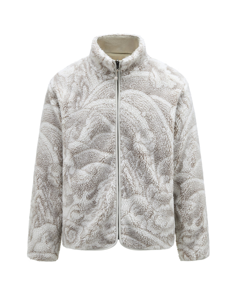 The TAUPE REVERSIBLE IREZUMI FLEECE by Sundae School is a light beige and white jacquard fleece jacket with a wavy, marble-like pattern, featuring a front zipper and a high collar.