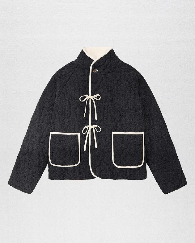 A female model wearing reversible black jeogori fleece 