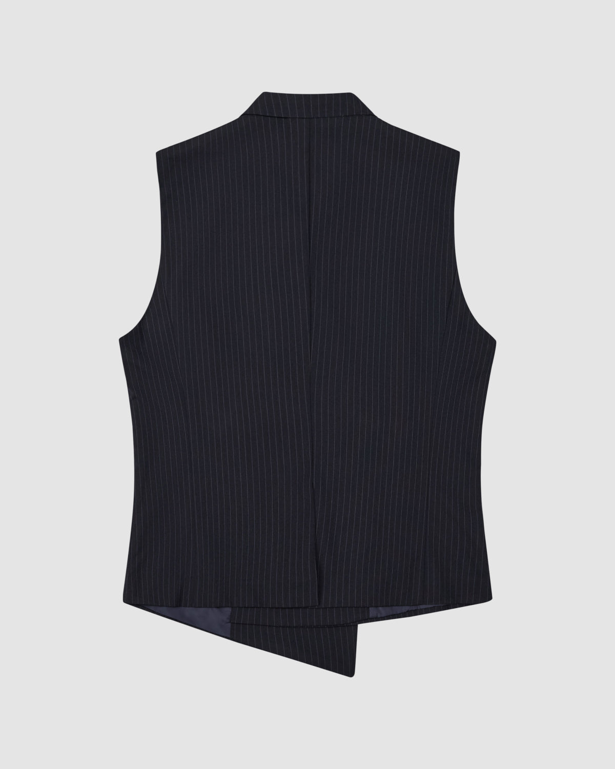 The SABRINA VEST by Sundae School is a black pinstriped summer wool formal vest with a straight collar and asymmetric hem, shown from the back on a light gray background.