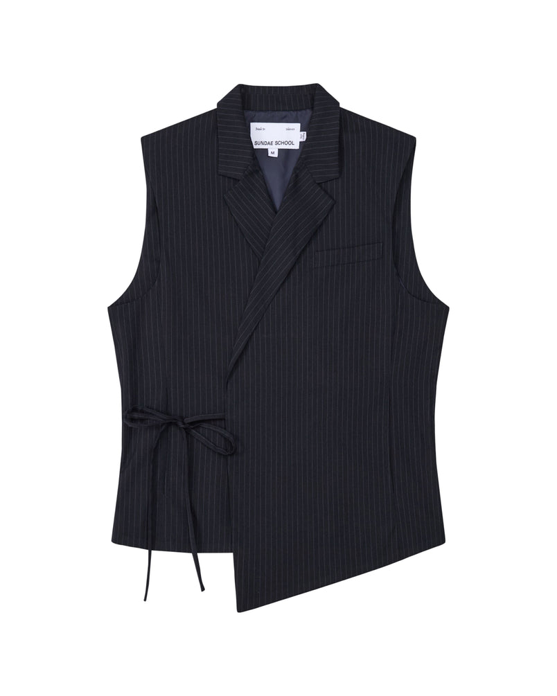 The SABRINA VEST by Sundae School is a sleeveless black pinstripe rayon blend vest featuring an asymmetric hem, side Korean goreum tie, lapel collar, and a single chest pocket, shown on a white background.
