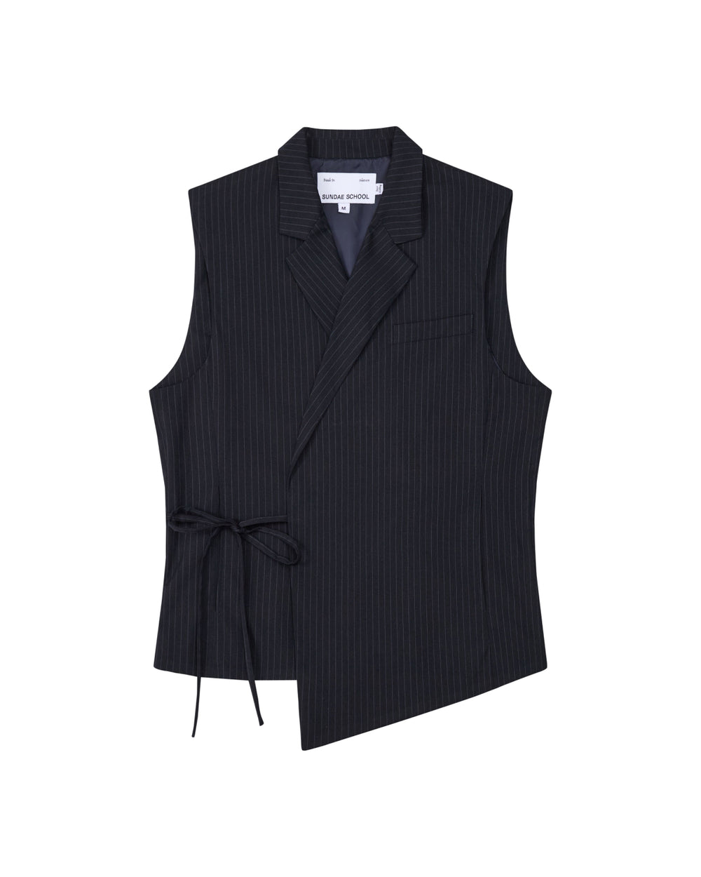 The SABRINA VEST by Sundae School is a sleeveless black pinstripe rayon blend vest featuring an asymmetric hem, side Korean goreum tie, lapel collar, and a single chest pocket, shown on a white background.