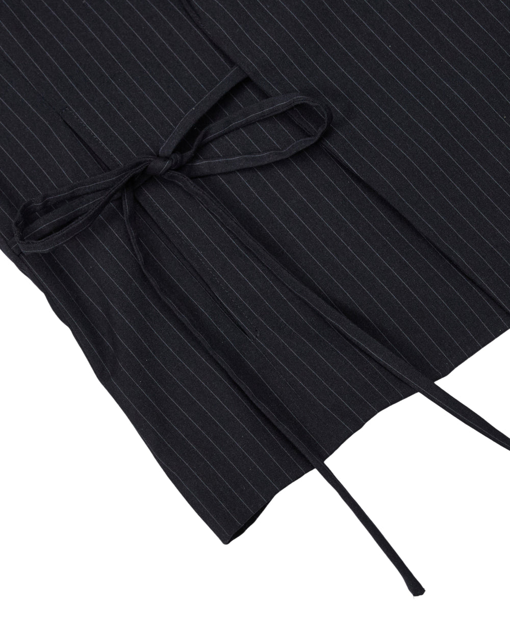 Close-up of the SABRINA VEST by Sundae School, crafted from a black rayon blend pinstripe fabric with thin white stripes, featuring a matching fabric belt tied in a neat bow inspired by the traditional Korean goreum tie.