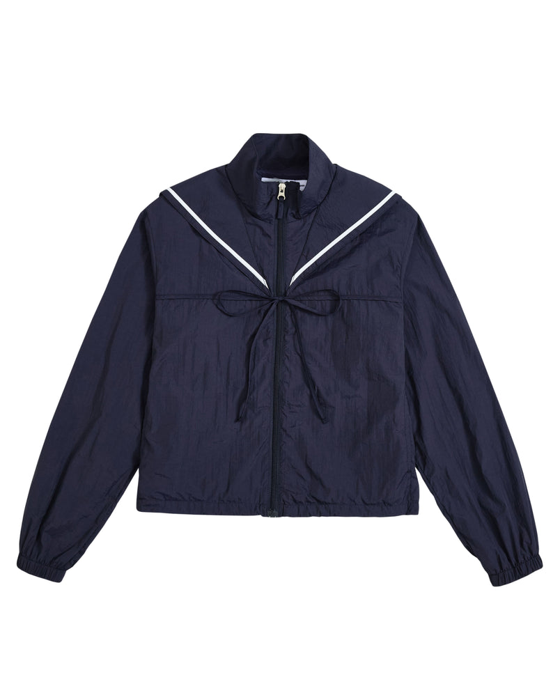 Introducing the NAVY SAILOR WINDBREAKER from Sundae School—a cropped zip-up jacket in navy blue, featuring a sailor-style collar with white trim and a front bow. The long sleeves have elastic cuffs, while the slightly crinkled texture adds modern flair. This playful windbreaker blends classic charm with contemporary style for a fresh look.
