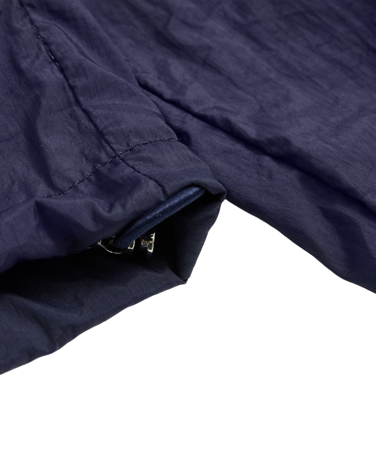 Close-up of the NAVY SAILOR WINDBREAKER by Sundae School, highlighting the dark blue cropped sleeve with a partially visible zipper at the cuff, set against a white background.