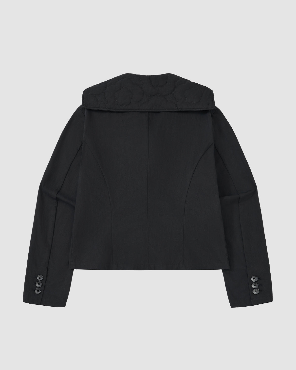 Back view of the BLACK SAILOR COLLAR UNIFORM JACKET by Sundae School—a black women’s blazer with long sleeves, button cuffs, wide sailor collar, and textured fabric in a structured fit inspired by classic Korean school uniforms.