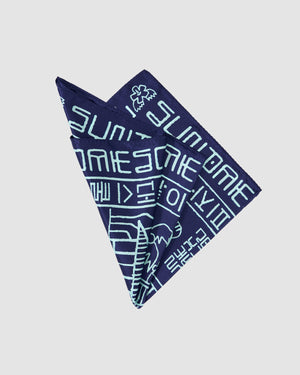The NAVY SILK BANDANA by Sundae School features light blue graphic and geometric patterns, including Hangeul script and Korean folk-inspired illustrations, folded neatly against a plain light background.