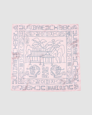 The PINK SILK BANDANA by Sundae School features soft pink silk with gray pavilion, tree, and cloud motifs at the center, bordered by stylized text and Hunminjeongeum script—a unique Korean heritage accessory.