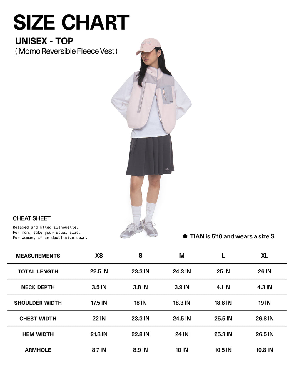 A person wearing the Sundae School BABY PINK MOMO REVERSIBLE FLEECE VEST over a gray top and gray skirt, paired with a cap and sneakers, stands in front of a white background featuring a size chart for the vest.