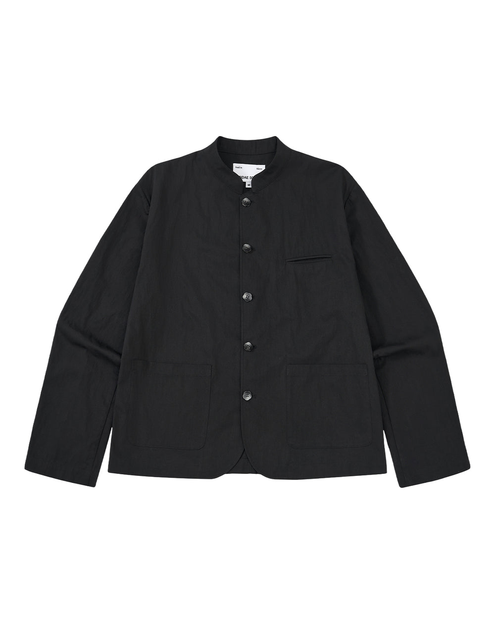 The BLACK STAND COLLAR UNIFORM JACKET by Sundae School is a black, wrinkle-resistant cotton-nylon jacket with long sleeves, button-up front, mandarin collar, two large front pockets, and a chest pocket, shown on a light gray background.
