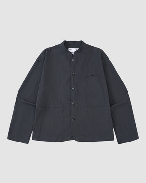 The Sundae School CHARCOAL STAND COLLAR UNIFORM JACKET, made from a cotton-nylon blend with long sleeves and three front pockets, is shown laid flat on a light gray background.