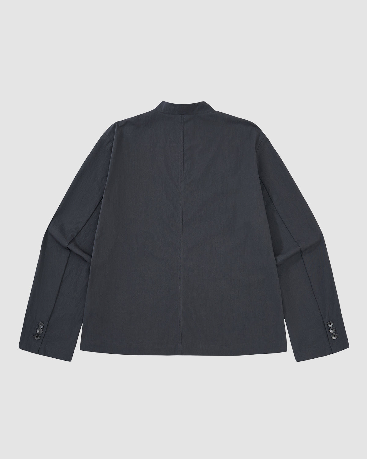Back view of Sundae School's CHARCOAL STAND COLLAR UNIFORM JACKET, a wrinkle-resistant, cotton-nylon blend blazer with buttoned cuffs, stand collar, center seam, and long sleeves, shown on a plain light background.