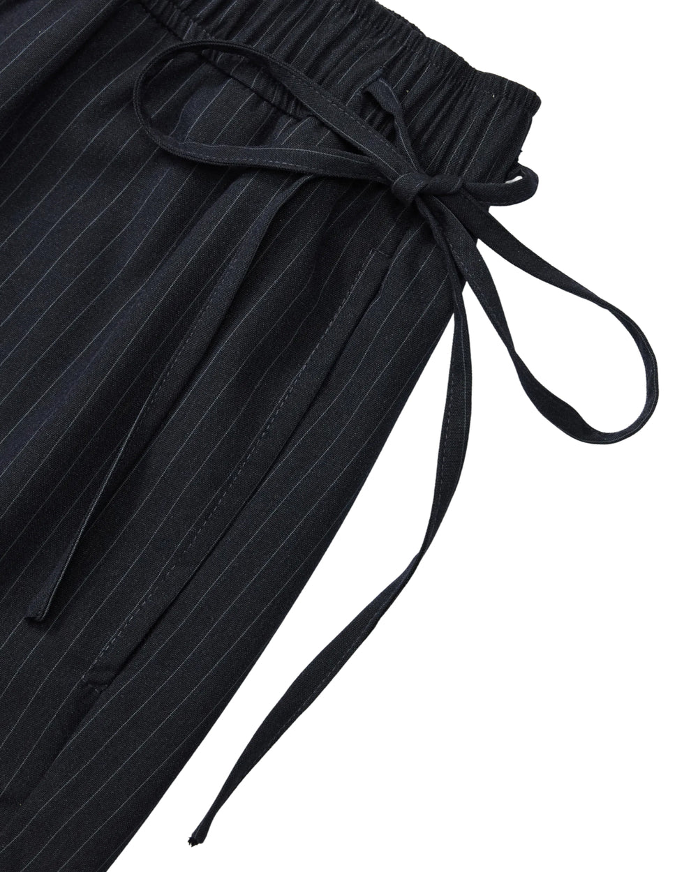 Close-up of Sundae School STRIPED BOXER SHORTS in black pinstripes, crafted from a lightweight rayon blend with an elastic waistband and a tied fabric belt.
