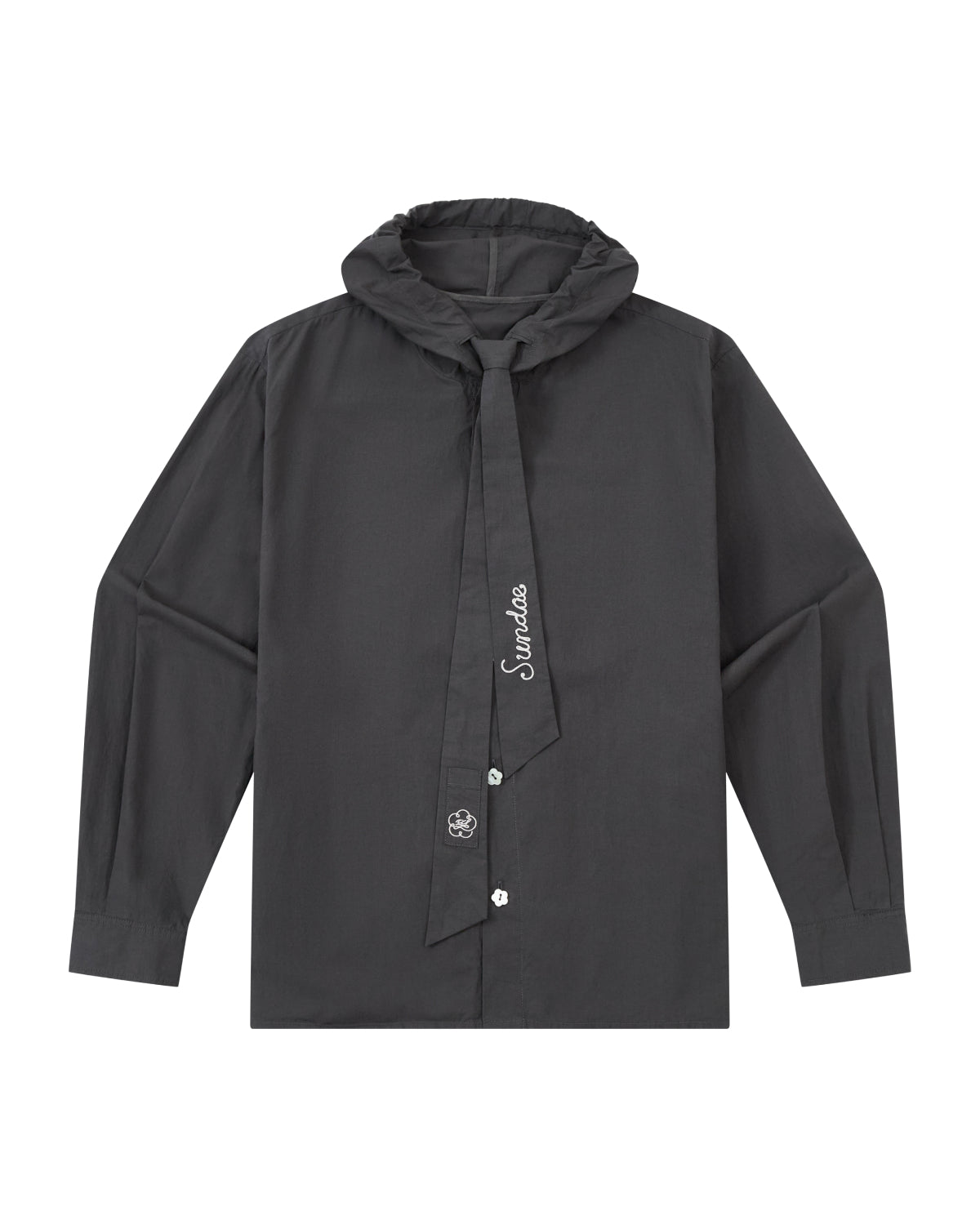 The CHARCOAL SUNBAE TIE SHIRT by Sundae School is a long-sleeve black button-up with a ruffled collar and an attached necktie adorned with white embroidery, featuring a simple, modern design.