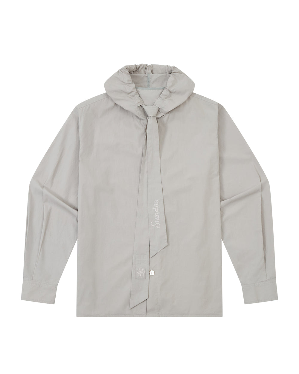 The GREY SUNBAE TIE SHIRT by Sundae School is a light gray, long-sleeve button-up featuring a wide, tied scarf collar with embroidered text. The shirt is displayed flat, showcasing its front details and button closures.