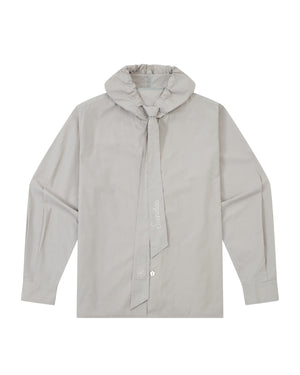 The GREY SUNBAE TIE SHIRT by Sundae School is a light gray, long-sleeve button-up featuring a wide, tied scarf collar with embroidered text. The shirt is displayed flat, showcasing its front details and button closures.