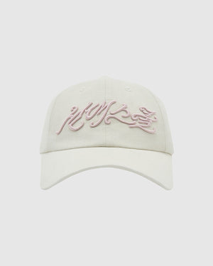 The IVORY DAENGGI CAP by Sundae School is a cream-colored adjustable cotton hat featuring "KINZ" embroidered in pink cursive, inspired by Korean styles for a fresh, modern look.