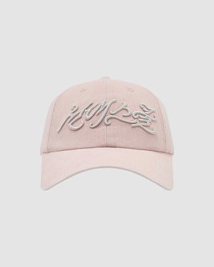 The BABY PINK DAENGGI CAP by Sundae School is a light pink adjustable cotton cap with white embroidered script on the front, shown against a light gray background—perfect for adding a trendy touch to any casual outfit.