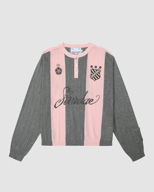 The PINK SUNDAE SOCCER JERSEY by Sundae School is a lightweight, long-sleeve 100% cotton top with vertical gray and pink stripes, buttoned collar, custom crest and UR patches, and "Sundae" embroidered on the front.