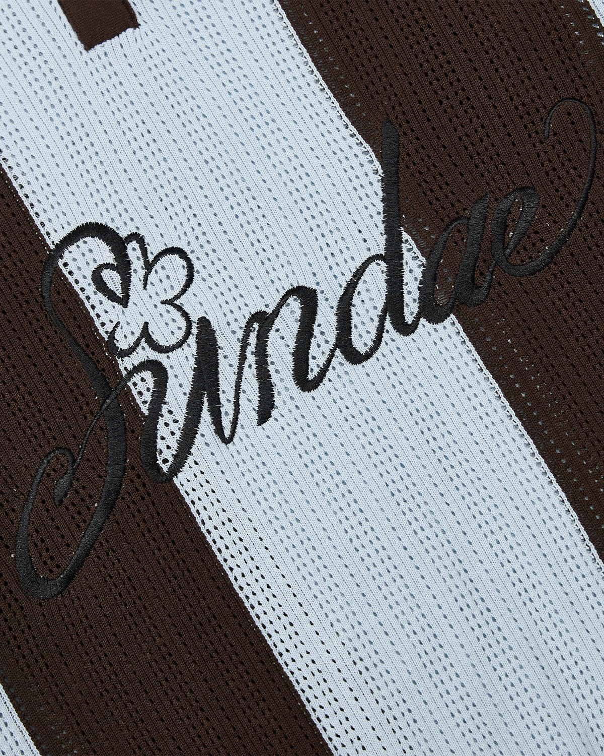 Close-up of the Sundae School SKY BLUE SUNDAE SOCCER JERSEY, featuring lightweight cotton knit fabric with white and brown vertical stripes. 