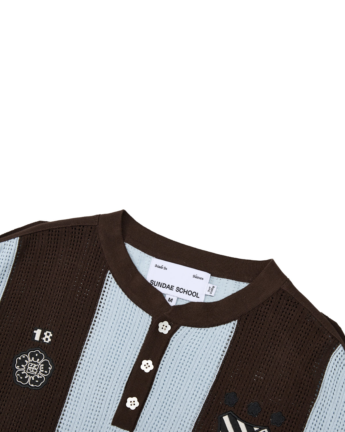 Introducing the SKY BLUE SUNDAE SOCCER JERSEY by Sundae School—a lightweight cotton knit shirt featuring brown and sky blue stripes, a round collar, floral mochi buttons, and embroidered chest patches including the number 18. Delicate floral embroidery and thoughtful detailing blend playful style with everyday comfort.