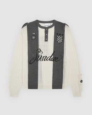 Butter Yellow Charcoal Sundae Soccer Jersey Knit flat lay featuring vertical striped ribbed knit construction, henley-style button placket with grey snap buttons, "Sundae" script embroidery across chest with decorative hibiscus flower accent, "18" number patch and floral crest on left chest, striped shield logo on right chest, displayed on light grey background.