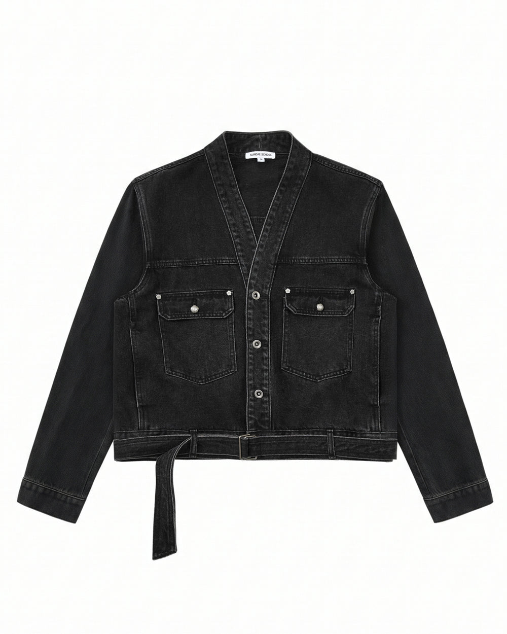 The BLACK WIDOW TAEKWONDO DENIM JACKET by Sundae School—a black, collarless V-neck denim jacket featuring a button front, double-buckle belt at the waist, and two flap chest pockets—offers a modern twist on the Korean Canadian tuxedo, shown here laid flat on a white background.
