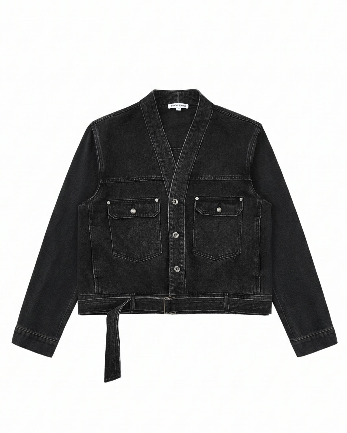 The BLACK WIDOW TAEKWONDO DENIM JACKET by Sundae School—a black, collarless V-neck denim jacket featuring a button front, double-buckle belt at the waist, and two flap chest pockets—offers a modern twist on the Korean Canadian tuxedo, shown here laid flat on a white background.