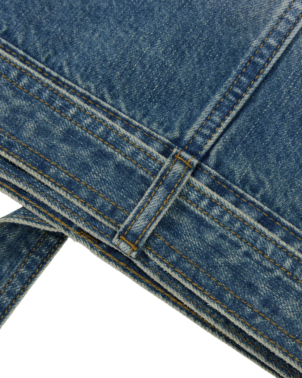 Close-up of blue denim fabric with visible stitching and seam details, featuring part of a belt loop and two overlapping edges, highlighting the texture and weave characteristic of the MEDIUM BLUE TAEKWONDO DENIM JACKET by Sundae School.