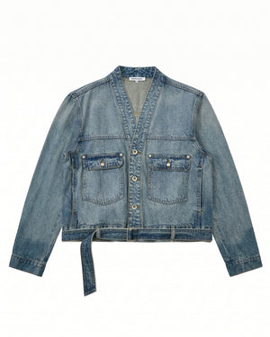 The MEDIUM BLUE TAEKWONDO DENIM JACKET by Sundae School features long sleeves, a V-neck collar, two front buttoned pockets, a button-down front, and a detachable waist belt—ideal for crafting your own Korean Canadian tuxedo look. Shown here laid flat on a white background.