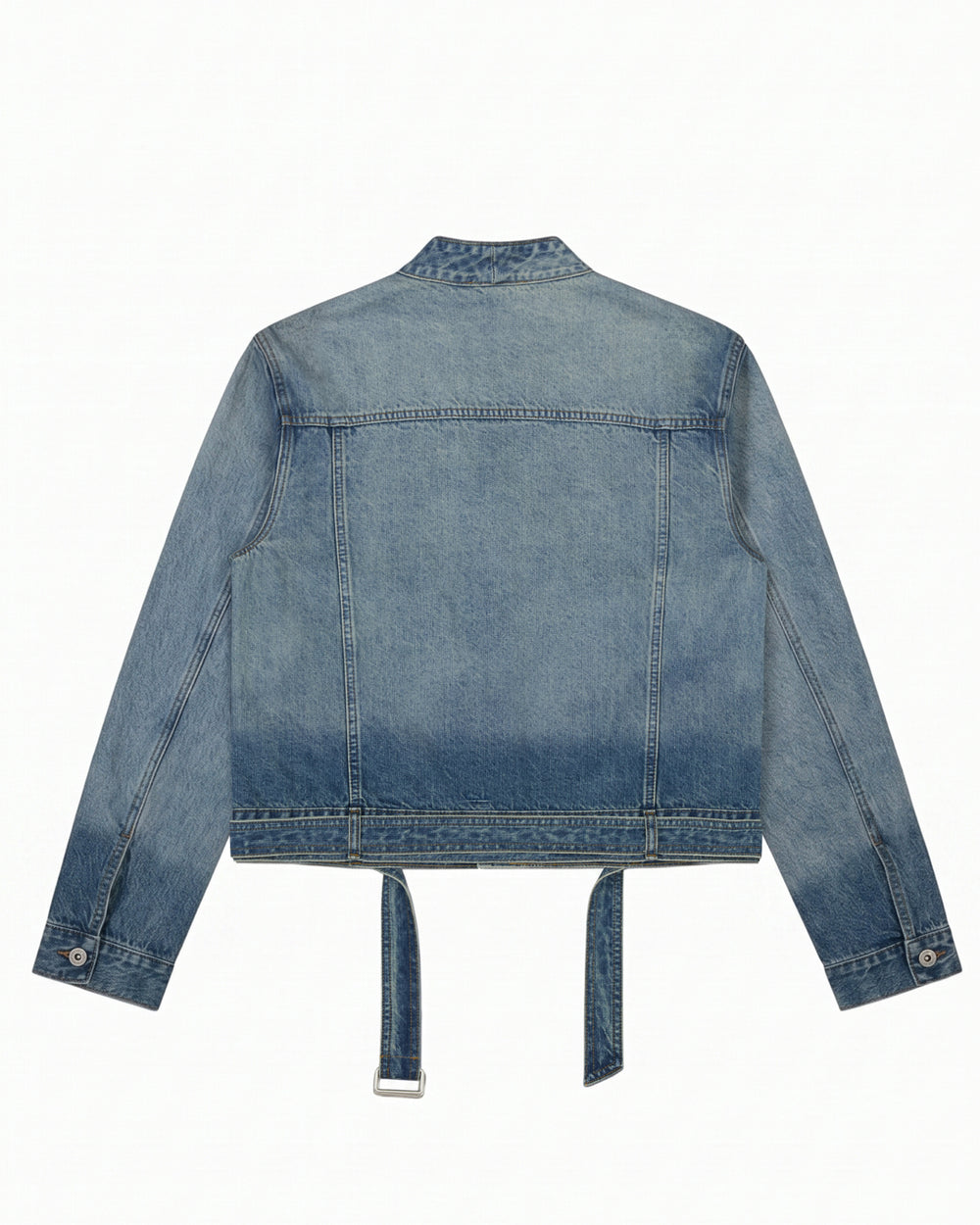 The MEDIUM BLUE TAEKWONDO DENIM JACKET by Sundae School is shown from the back in a faded blue wash, featuring long sleeves with buttoned cuffs and two denim straps hanging from the bottom hem for a modern Korean Canadian tuxedo vibe.