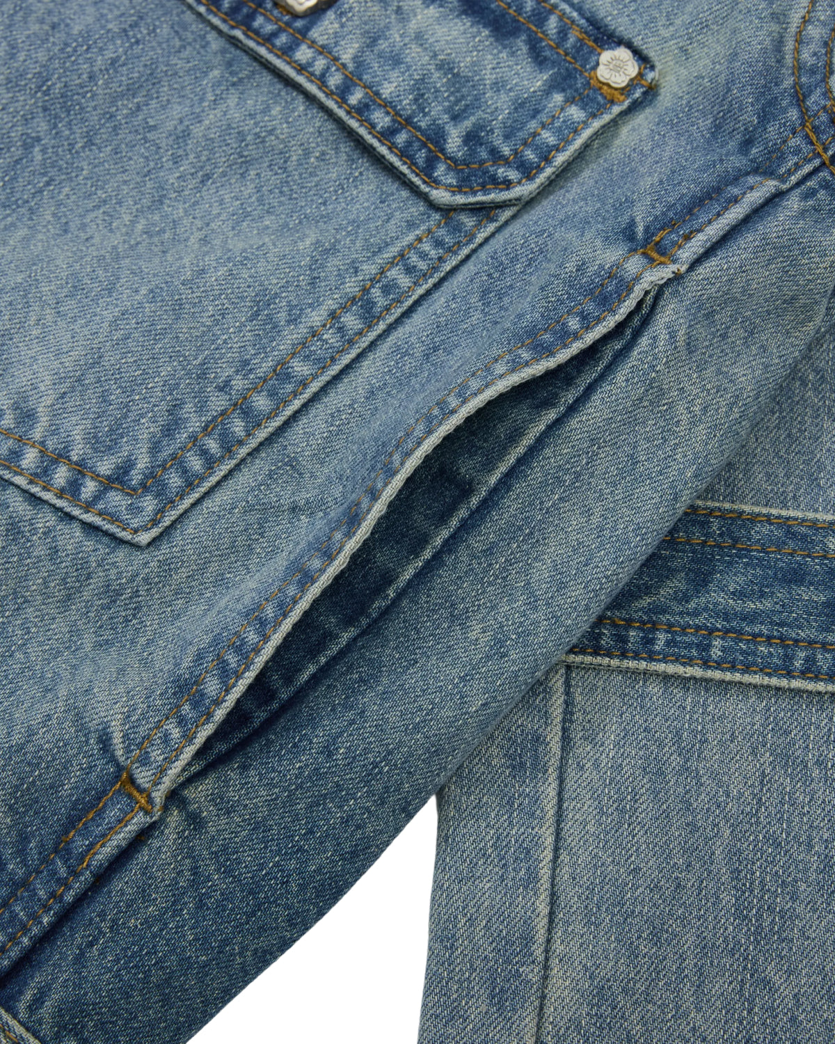 Close-up of the MEDIUM BLUE TAEKWONDO DENIM JACKET by Sundae School, highlighting the denim pocket with visible stitching and a metal button. The worn texture and fabric lines are clearly visible, capturing the classic style of a Korean Canadian tuxedo.