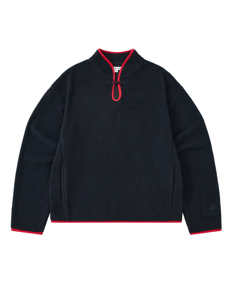 A cozy navy fleece pullover named the NAVY TEARDROP KNOT FLEECE by Sundae School, featuring a short zipper, red trim on the collar, cuffs, and hem, and long sleeves. This East Asian inspired garment is displayed laid flat on a white background.