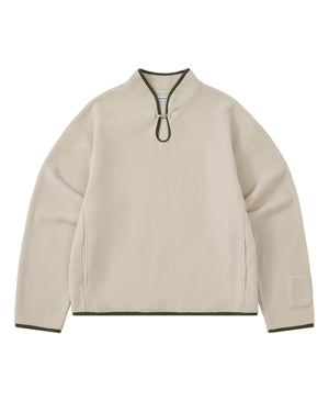 Introducing the TAUPE TEARDROP KNOT FLEECE from Sundae School: this cozy fleece pullover features long sleeves and a rounded collar with a front loop closure. Dark green trim accents the collar, cuffs, and hem, while its minimalistic design is elevated by subtle East Asian-inspired details for a timeless aesthetic.