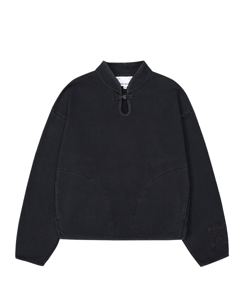 Introducing the BLACK TEARDROP KNOT SWEATSHIRT from Sundae School—a minimalist, loose-fitting pullover crafted from 100% cotton. This black sweatshirt features long sleeves, a high collar with a front drawstring tie, curved seam details on the front, and a small patch adorning the left sleeve.